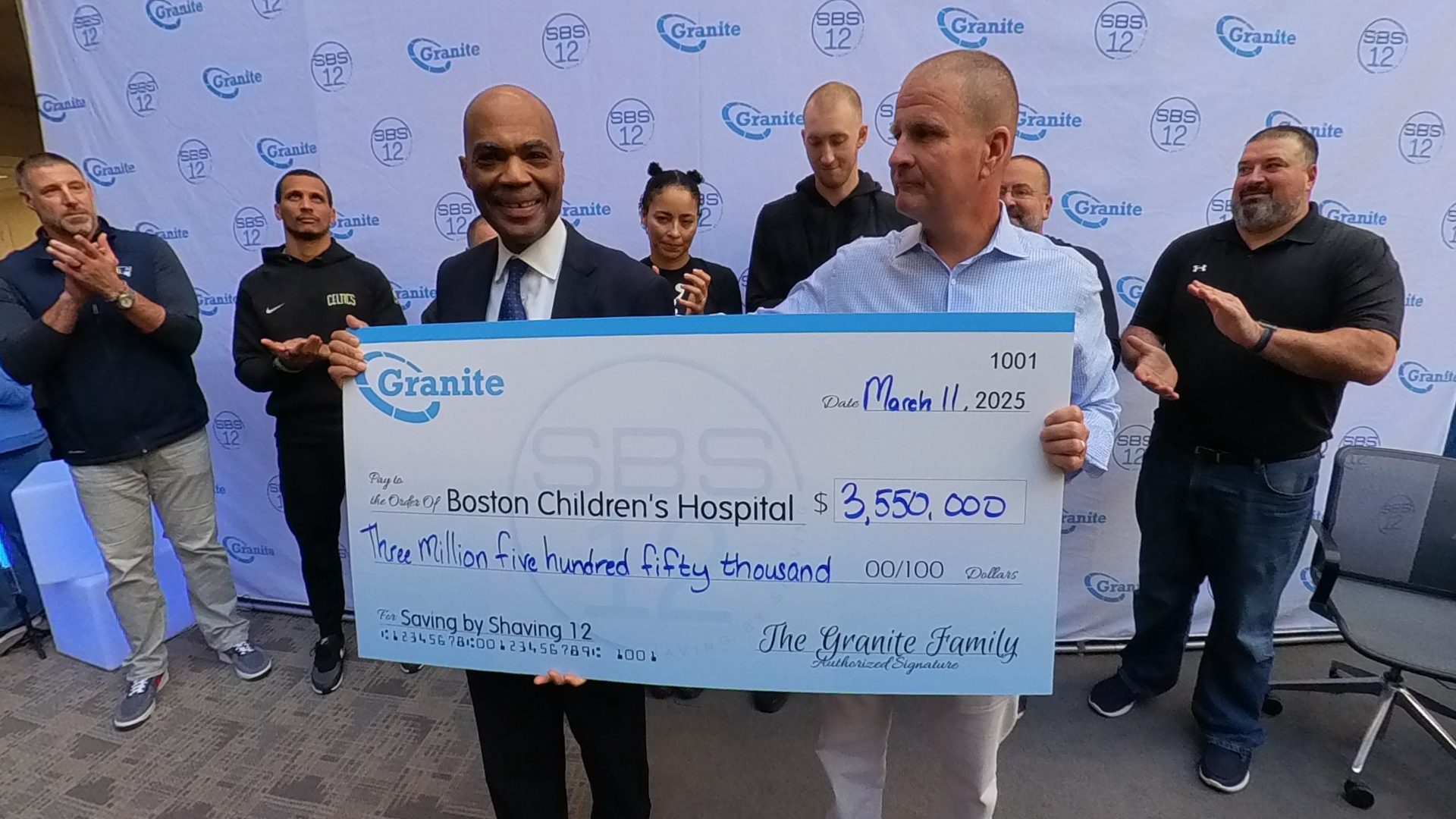 Granite CEO Rob Hale presents a check to Kevin Churchwell, MD, President and CEO of Boston Children’s Hospital at Granite’s 12th Annual Saving by Shaving event.